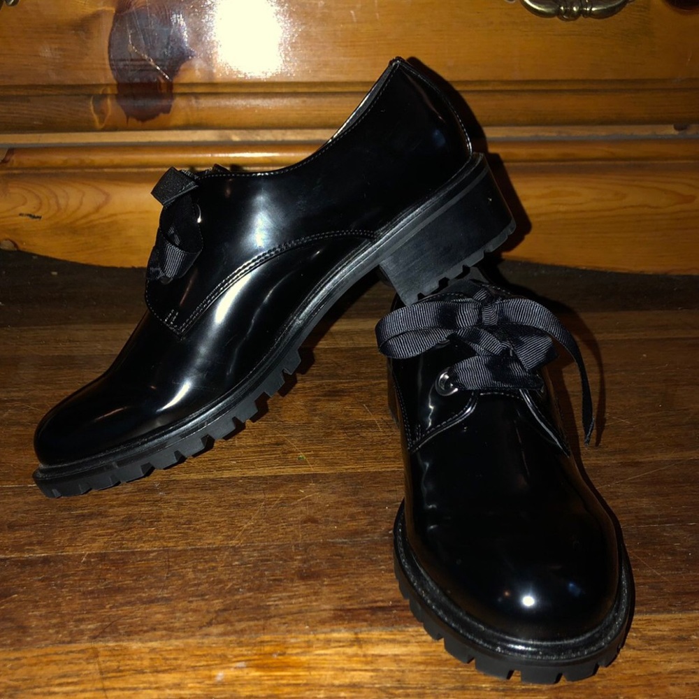 Shiny black oxford type shoes with ribbon laces.